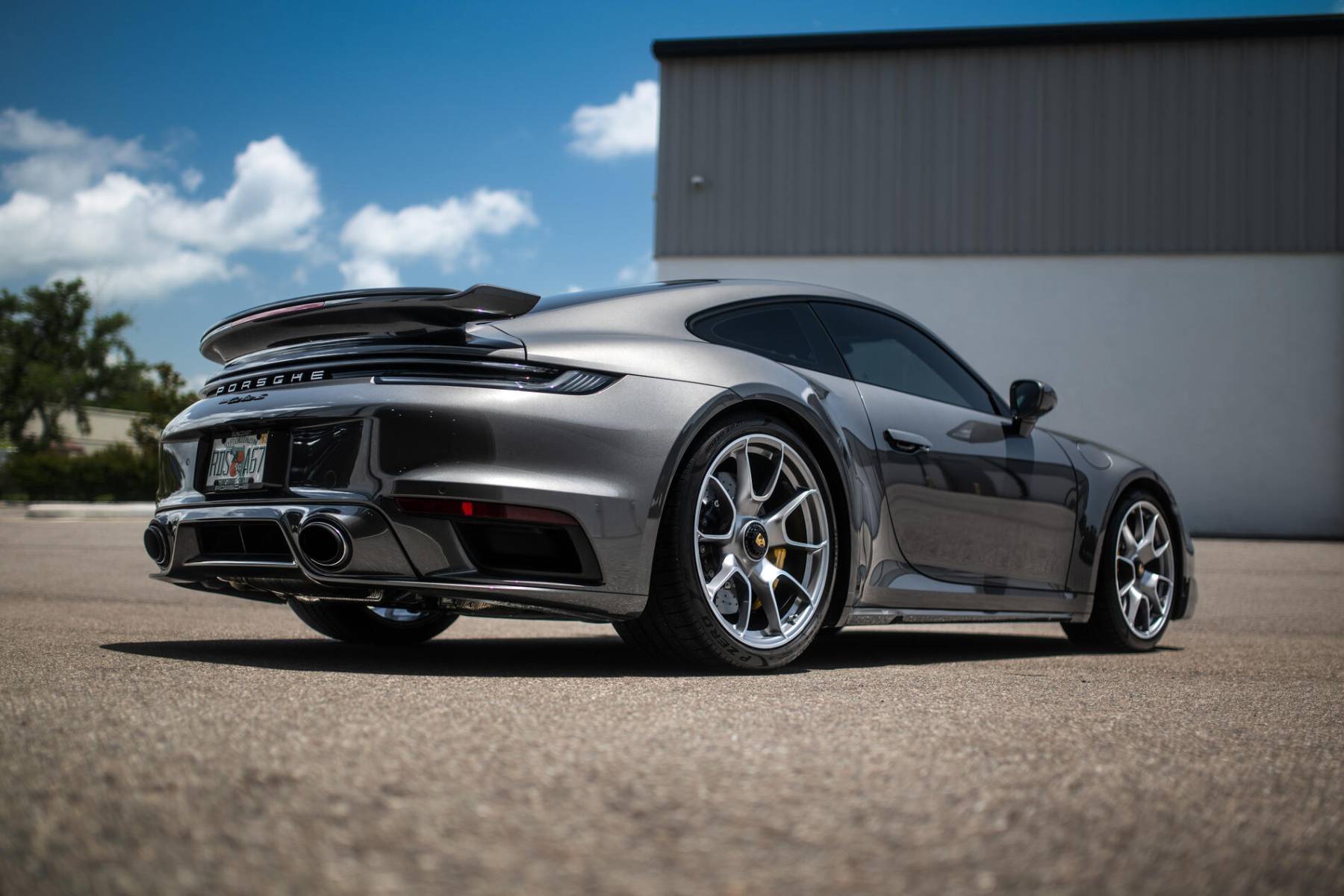 Gray Porsche 911 Turbo S, rear three-quarter view
